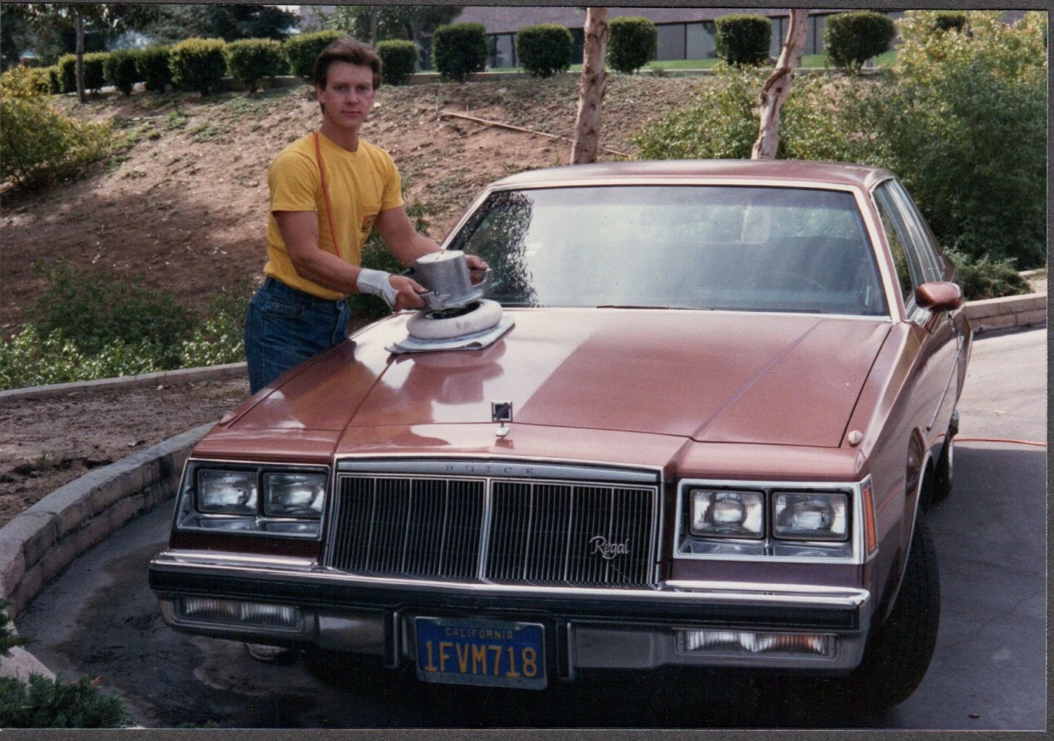 Kevin polishing a brown sedan for Sunshine Polishing